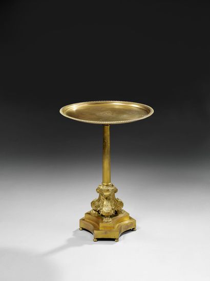 null A gilt copper pedestal table, the top inscribed UNICA VIRTUS NECESSARIA under...