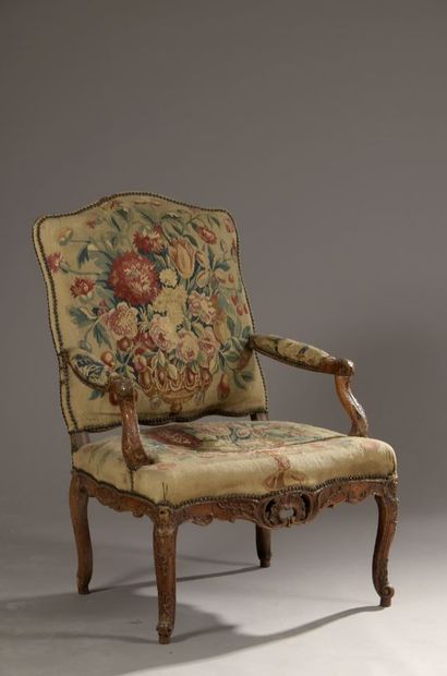 null Armchair with flat back in walnut, moulded and carved with rocaille cartouches,...