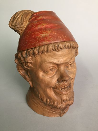 null Bearded man's head, smiling, with fez. 

Painted and patinated terracotta

H....