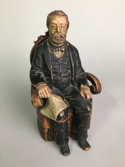 null GAMBETTA (1838-1882) assis sur son fauteuil, avec son journal sur les genoux....