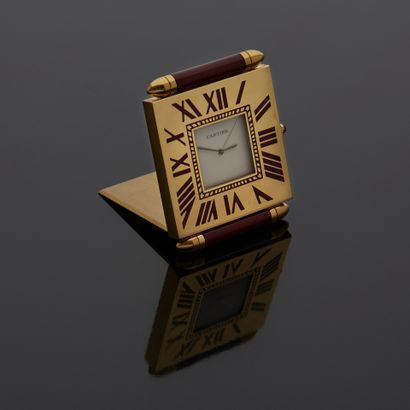 null CARTIER - Gilt metal travel clock, Must model. Signed square dial, cream background,...
