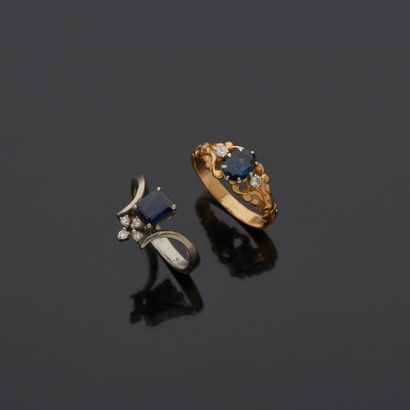 null Lot including:

- an 18K 750‰ two-tone gold ring, set with an oval-shaped (heated)...