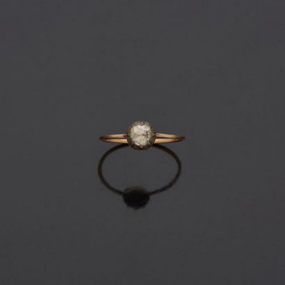 null Lot including:

- an 18K 750‰ two-tone gold ring, set with an oval-shaped (heated)...