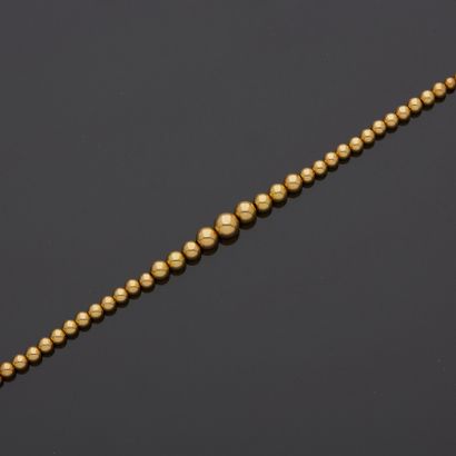 null Yellow gold 18K 750‰ Marseillais necklace, consisting of a fall of balls, arranged...