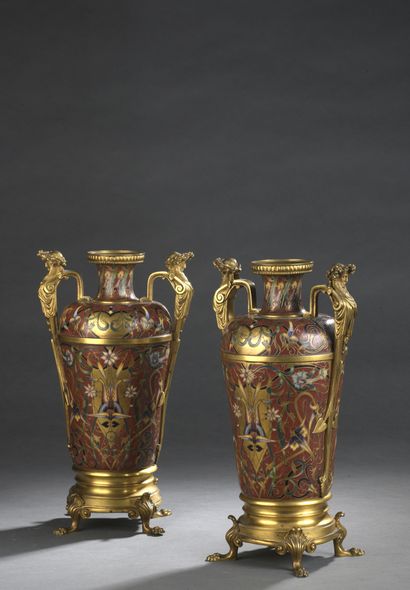 null Pair of gilt bronze vases with flared cylindrical necks decorated with champlevé...