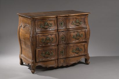 null A walnut three-drawer chest of drawers with a crossbow front and curved sides,...