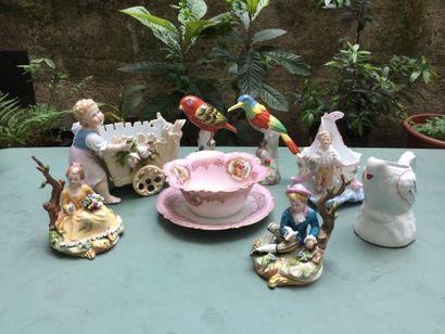  Lot in porcelain or biscuit including : 
- 2 groups representing a young man and...