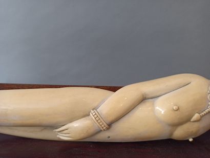  Carved ivory subject enhanced with ink, representing a reclining nude woman, called...