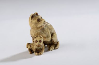 null Ivory netsuke, sitting bitch, her cub between her paws, eyes inlaid.


Signed...