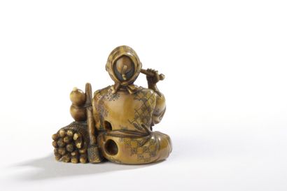 null Ivory netsuke with yellow patina, woodcutter sitting, a faggot and his axe at...