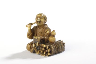  Ivory netsuke with yellow patina, woodcutter sitting, a faggot and his axe at his...