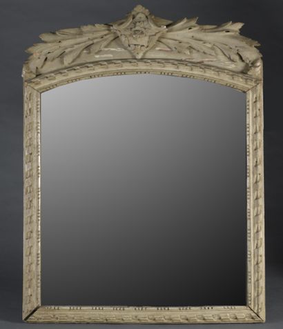 null A molded wood mirror with a pediment carved with twisted ribbons, topped by...
