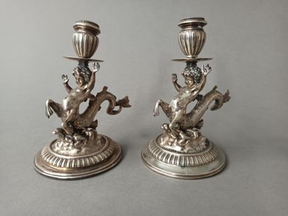 null Pair of small silver candlesticks decorated with a young marine centaur. Binnacles...