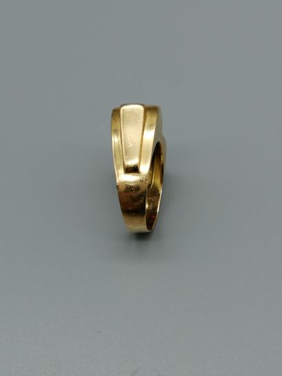 null An 18K 750‰ two-tone gold ring, of geometric form, set with calibrated red stones...