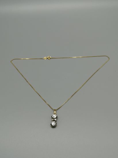 An 18K 750‰ two-tone gold pendant, adorned...