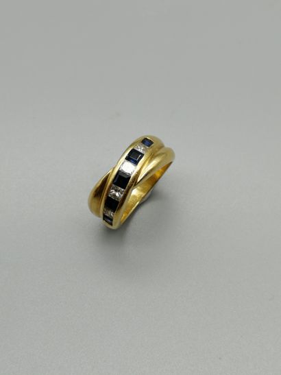 An 18K yellow gold 750‰ cross band ring,...