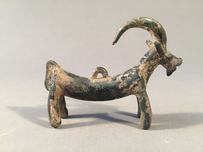 Large pendant representing a goat. Bronze....