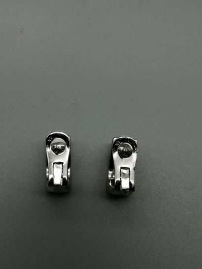 null A pair of 18K white gold 750‰ ear clips, rectangular in shape, adorned with...