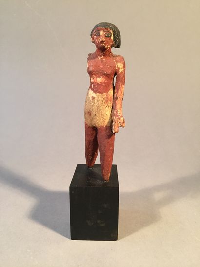 null Lot composed of an Egyptian style polychrome stuccoed wood figure, an Egyptian...