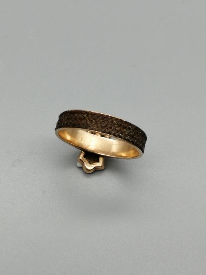 null 9K yellow gold ring 375‰, ring surrounded by braided hair, in the center two...