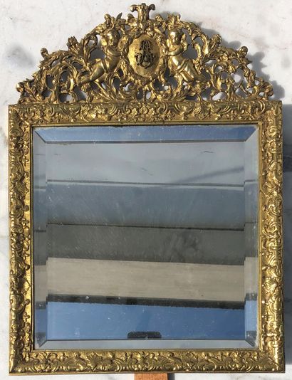 null A gilt bronze table mirror with cherubs and a monogrammed medallion. 37 x 28...