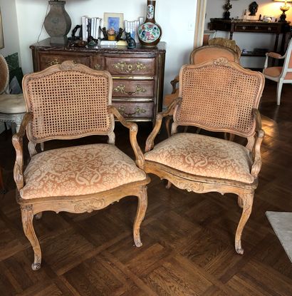 null A pair of moulded and carved wood caned armchairs with rocaille decoration,...