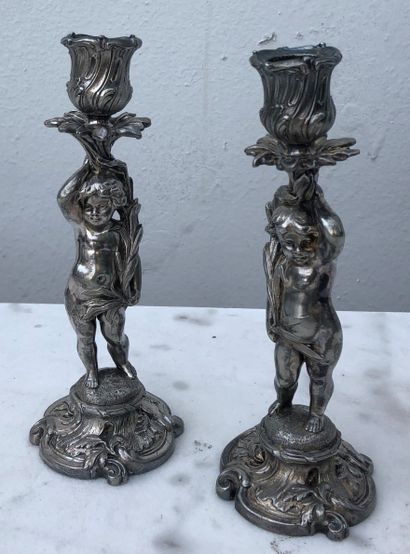 null Pair of silver-plated cast iron candlesticks with rocaille decoration supported...