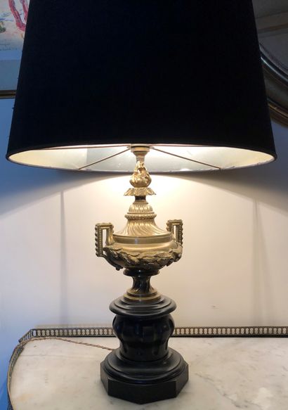null A pair of ormolu cassolette vases on a black Namur marble base, mounted as lamps.

H....