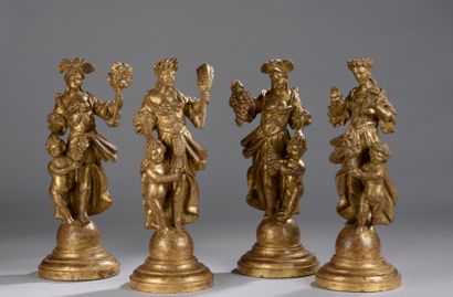 null SET OF FOUR Gilded and carved wood SUJETS representing the four seasons.

Italian...