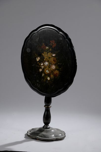 null A blackened wood tilting pedestal with painted flowers and mother-of-pearl incrustations....