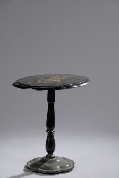 null A blackened wood tilting pedestal with painted flowers and mother-of-pearl incrustations....