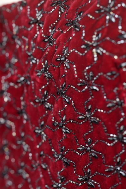 null Evening dress in red silk velvet entirely embroidered with black pearls.

Manufacture...