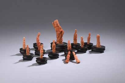 null Set of 14 orange-red coral figurines* featuring young women and a standing Taoist...