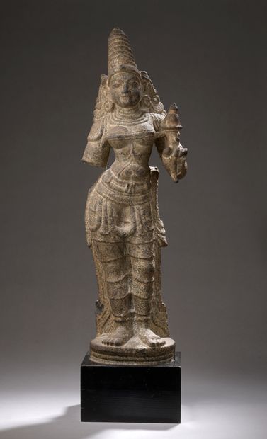 null Grey granite STATUTE depicting Durga, a lotus in her left hand, her head surmounted...