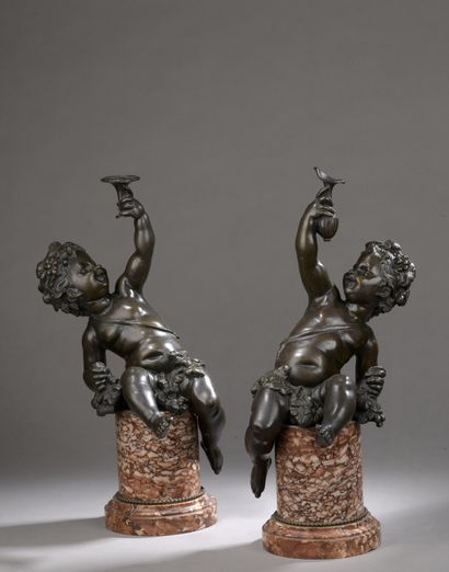 null TWO STATUETTES of young Bacchus holding a cup, in patinated bronze, after Clodion.

Cylindrical...