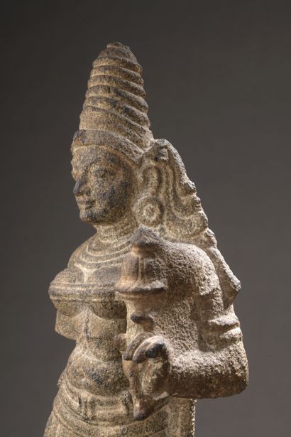 null Grey granite STATUTE depicting Durga, a lotus in her left hand, her head surmounted...