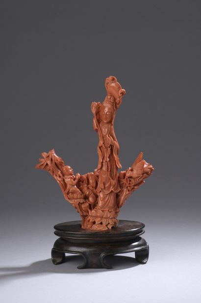 null Statuette in orange-red coral* representing a young woman standing with a lotus...