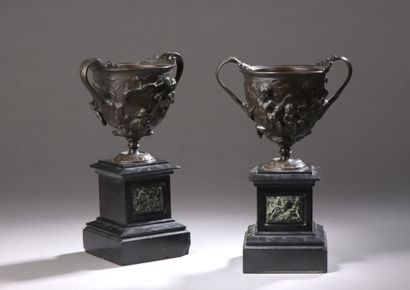 null A PAIR OF POCKET CUPS in bronze with medal patina and decorated in high relief...