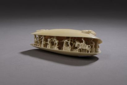 null 
A carved openwork ivory SUBJECT, representing a shell in which are carved characters,...