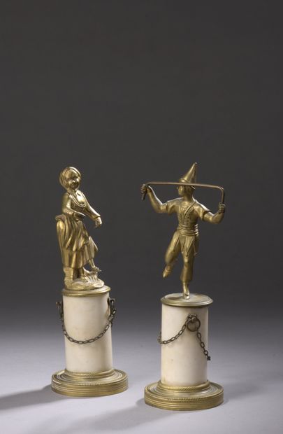 null TWO ormolu STATUETTES, girl with scarf and comedy character. Marble pedestal,...