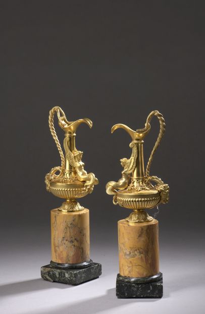 null Pair of miniature high necked gilt bronze ewers, decorated with a winged mermaid,...