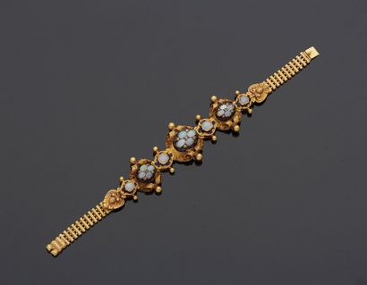 null 18K yellow gold 750‰ bracelet, composed of articulated motifs adorned with leather,...