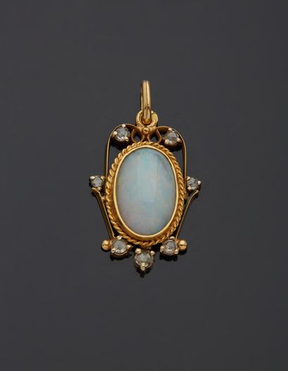 null An 18K yellow gold 750‰ pendant, oval in shape, adorned with an opal surrounded...