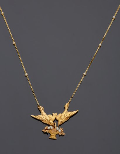 null An 18K yellow gold 750‰ necklace adorned with two birds holding a pearl-embellished...