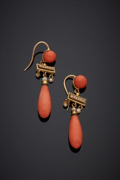 null A pair of 18K yellow gold 750‰ pendant earrings, adorned with a coral tassel...