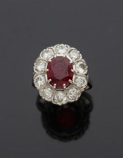 null Platinum ring 850‰, set with an oval-shaped (seeded) ruby, in a surround of...