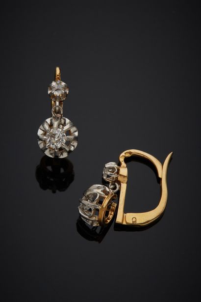 null A pair of articulated two-tone 18K gold 750‰ sleeper earrings set with an old-cut...