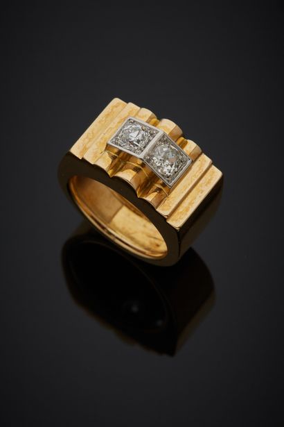 null 18K yellow gold 750‰ and platinum 850‰ bridge ring, set with two old-cut diamonds....