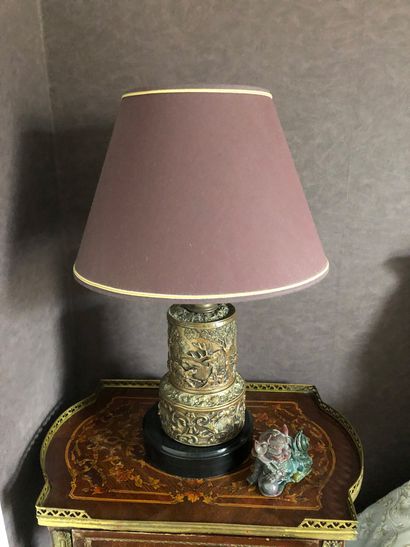 null Pair of repoussé metal lamps decorated with hunting scenes on black stone bases


Total...