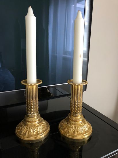null A pair of small ormolu candlesticks, fluted shaft, worn, Louis XVI style


H...